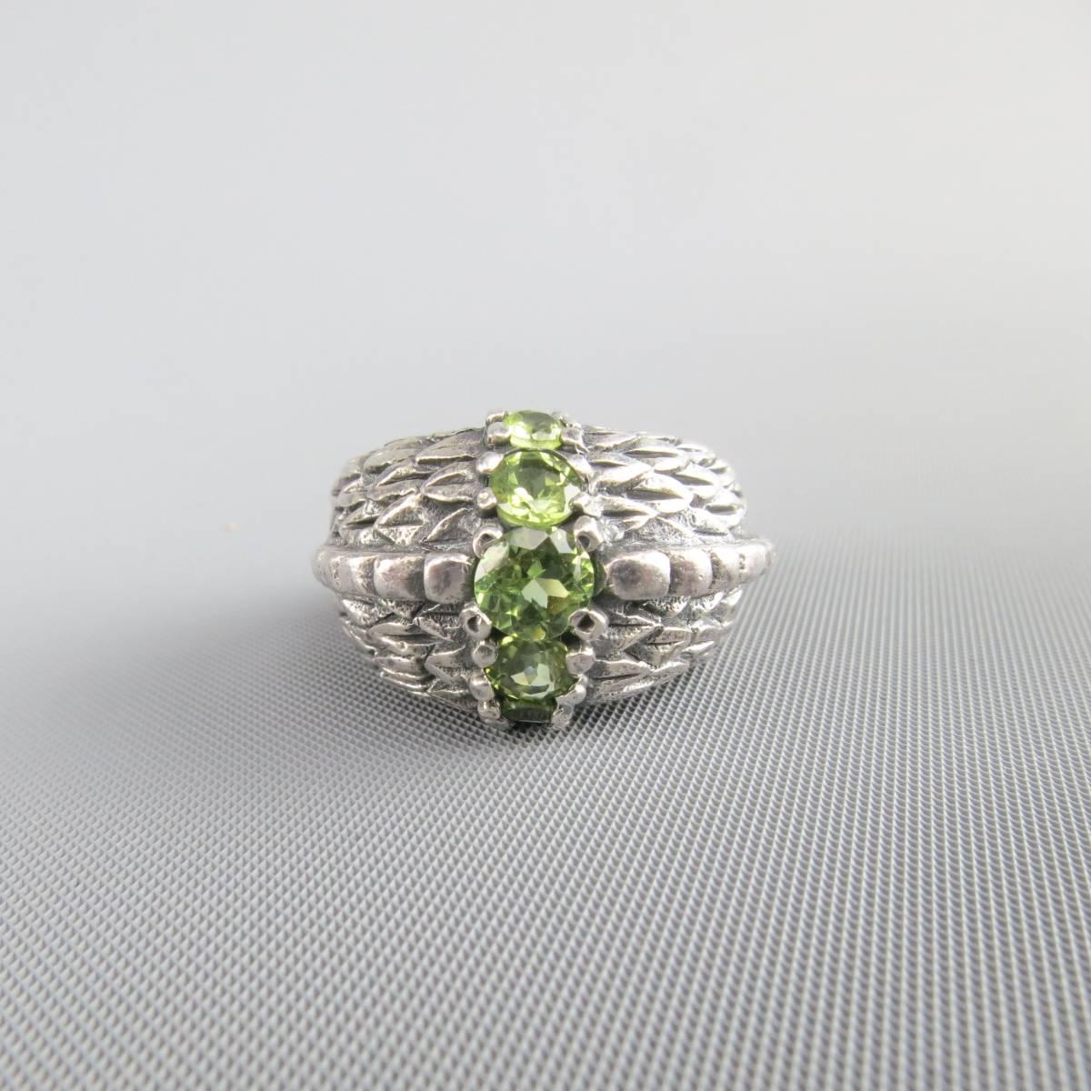 Vintage sterling silver ring featuring an engraved armor textured band with a row of green gems in cascading sizes.
 
Good Pre-Owned Condition.
 
Size: 7.5
