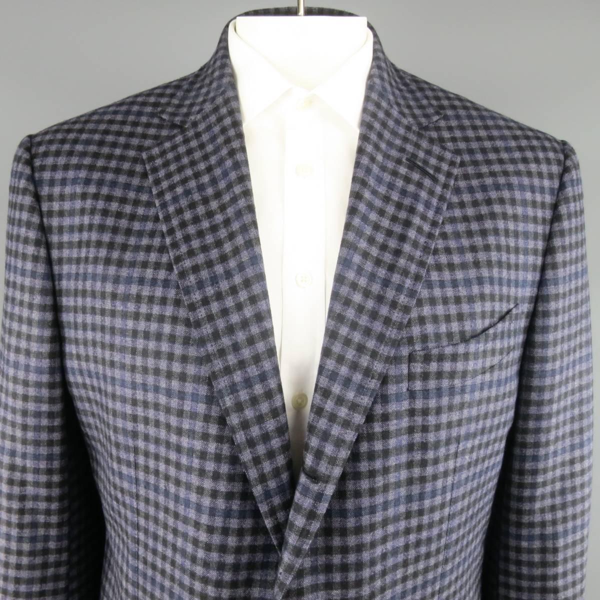 This TOM FORD three button sport coat comes in a muted lavender purple wool with an all over navy blue and black checkered plaid pattern and features a classic notch lapel, patch pockets, functional button cuffs, and half lining. Made in