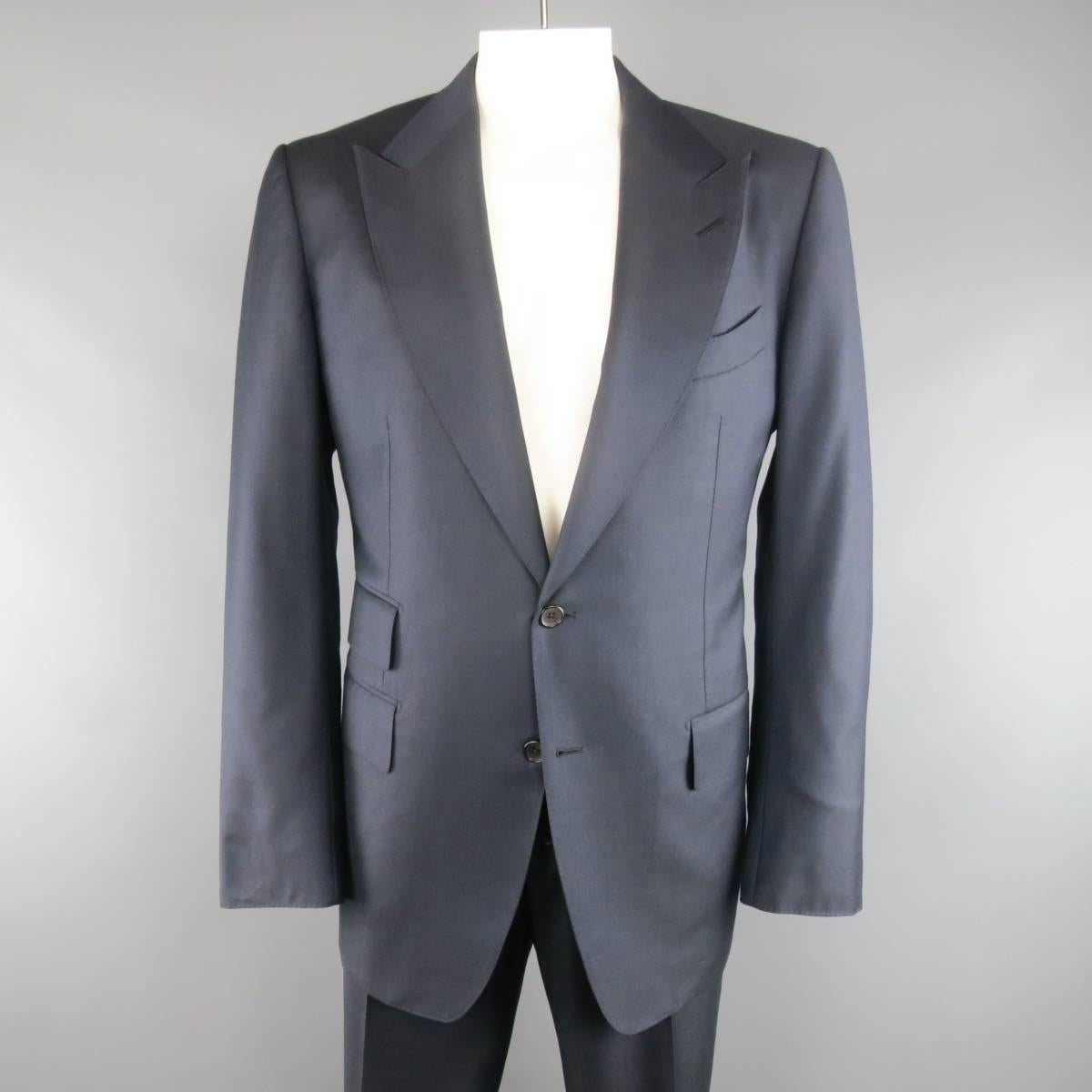 TOM FORD suit comes in a navy blue wool and includes a two button sport coat with peak lapel, three flap pockets, and functional button cuffs with matching adjustable tab waistband dress pants with cuffed hem. Made in Italy.
 
Excellent Pre-Owned