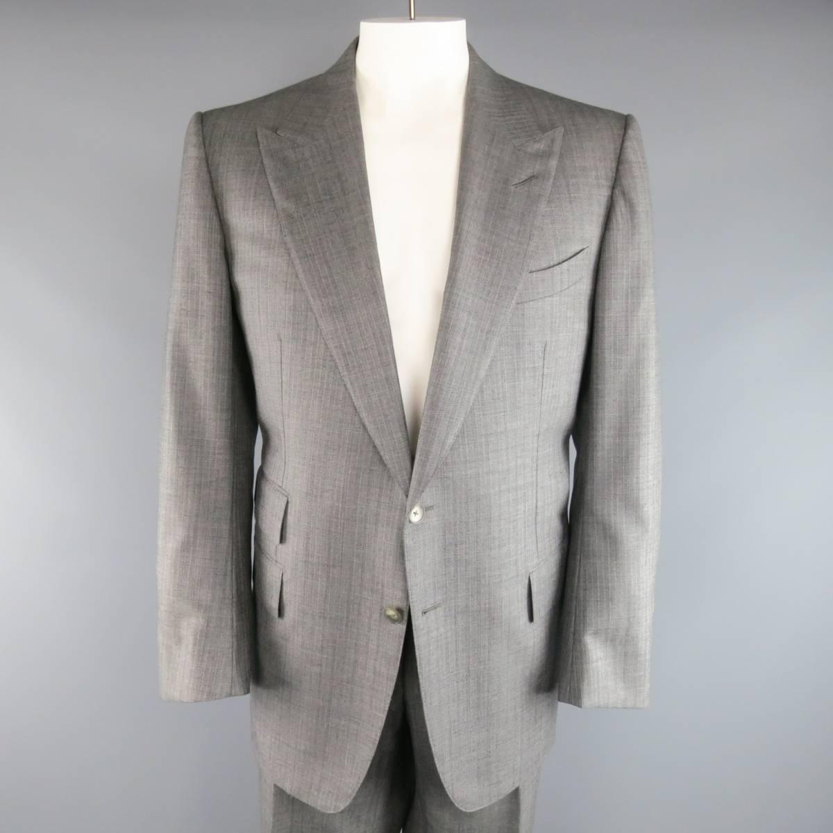 Tom Ford two piece suit comes in a gray herringbone wool fabric and includes a two button, peak lapel sport coat with flap pockets, and functional button cuffs with matching flat front, adjustable tab waistband dress pants. Made in Italy.

Excellent