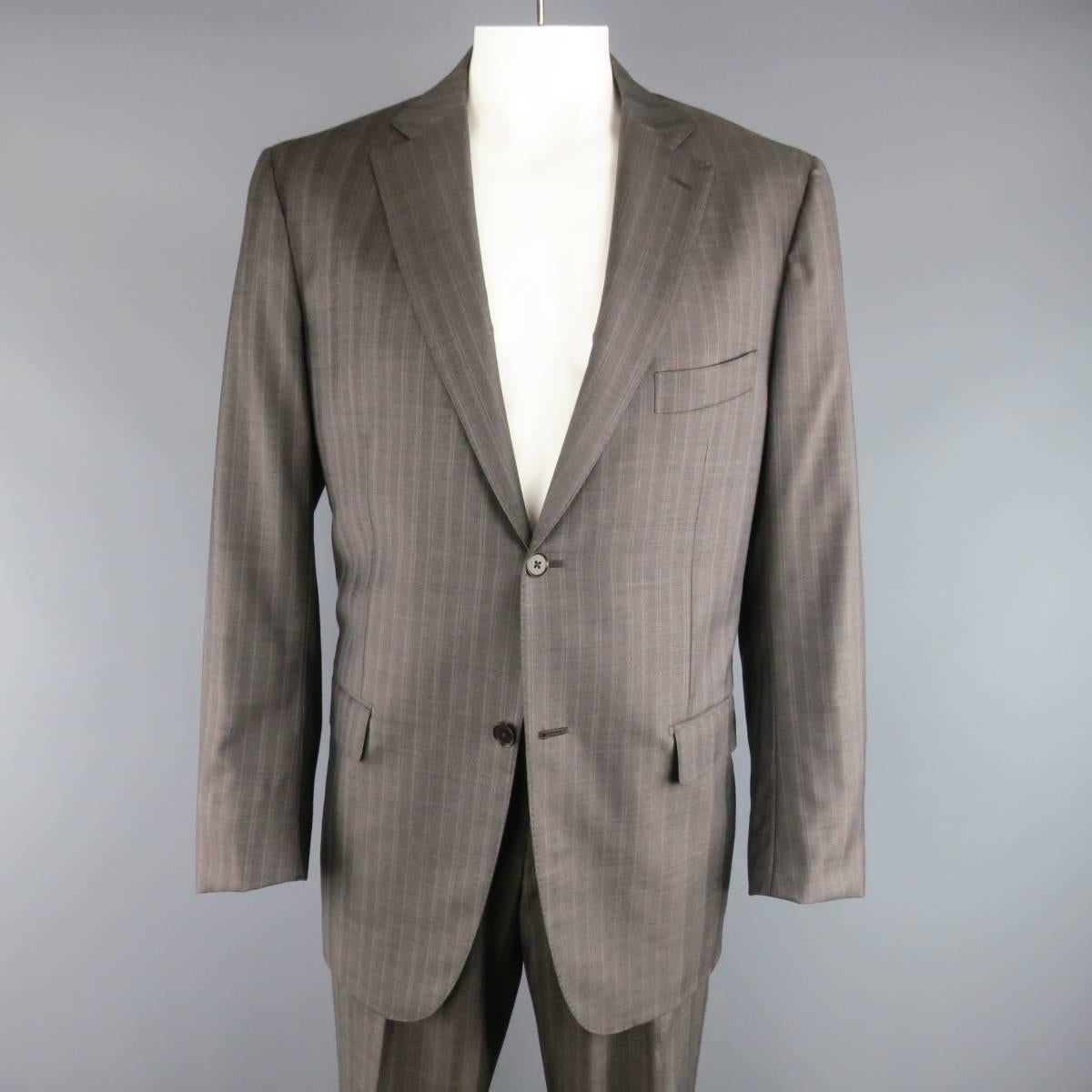 ISAIA two piece suit comes in a taupe gray wool with all over muted lavender stripe pattern and includes a two button, notch lapel sport coat with functional button cuffs and matching flat front dress pants. Made in Italy.
 
Excellent Pre-Owned