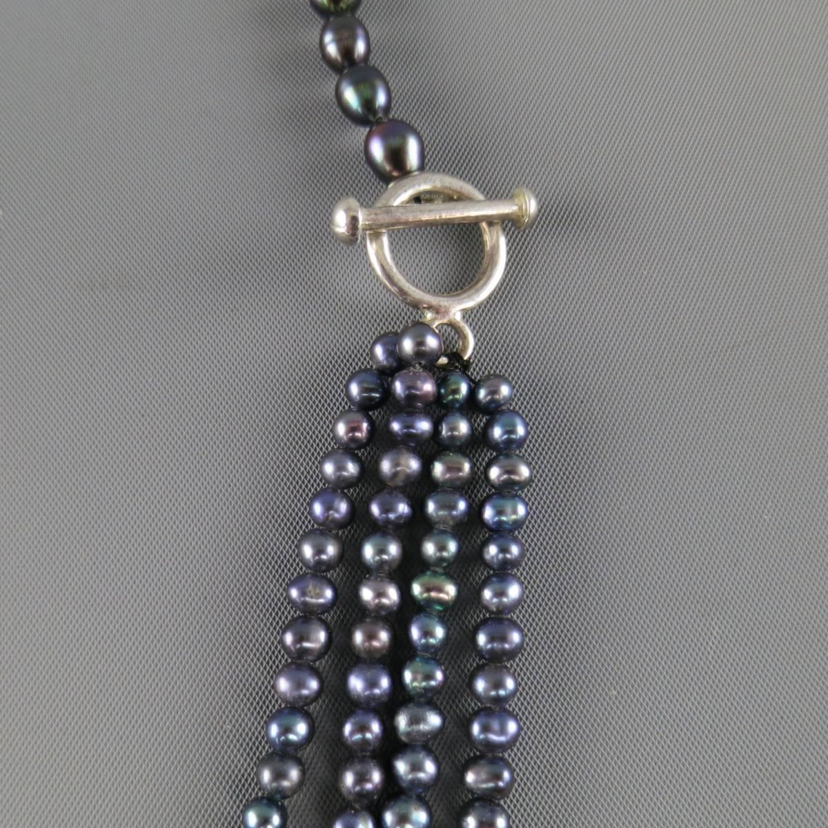This vintage necklace features a single and three strand asymmetrical composure of black pearls with with pearls throughout and sterling silver closure.
 
Good Pre-Owned Condition.
 
Length: 18.5 in.


Web ID: 82052 