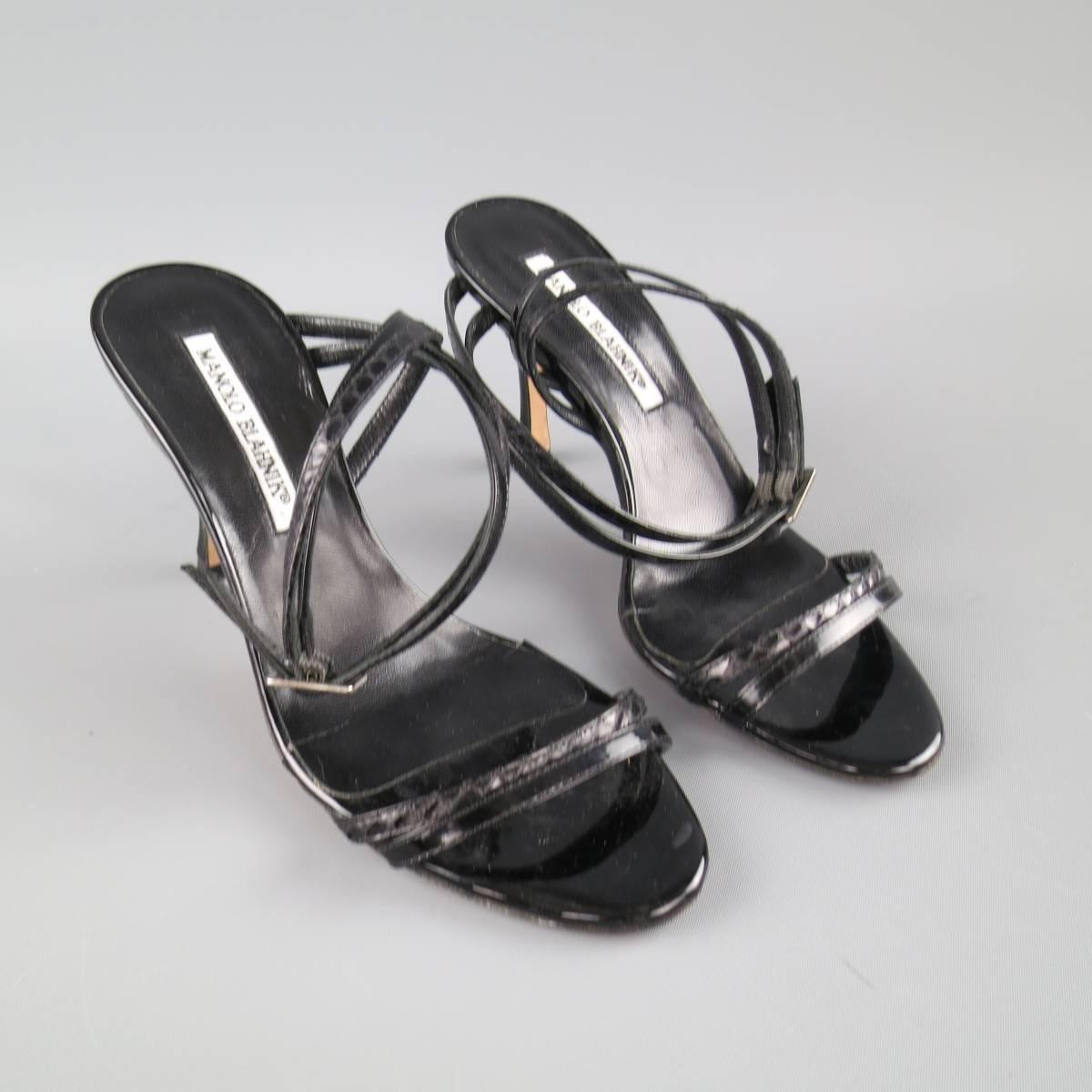 MANOLO BLAHNIK sandals come in a high gloss black patent leather with snake skin details and feature a double skinny toe strap, covered stiletto heel, and asymmetrical wrapped ankle straps. Made in Italy.
 
Good Pre-Owned Condition.
Marked:IT 36.5
