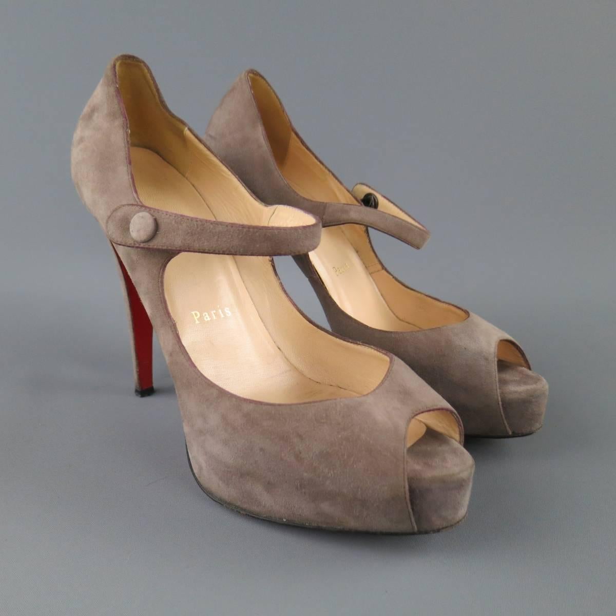 CHRISTIAN LOUBOUTIN pumps in a light taupe gray suede featuring a Mary Jane strap with covered button, peep toe with concealed platform, and covered stiletto heel. Wear throughout. As-Is. Made in Italy.
 
Fair Pre-Owned Condition.
Marked: IT 40

