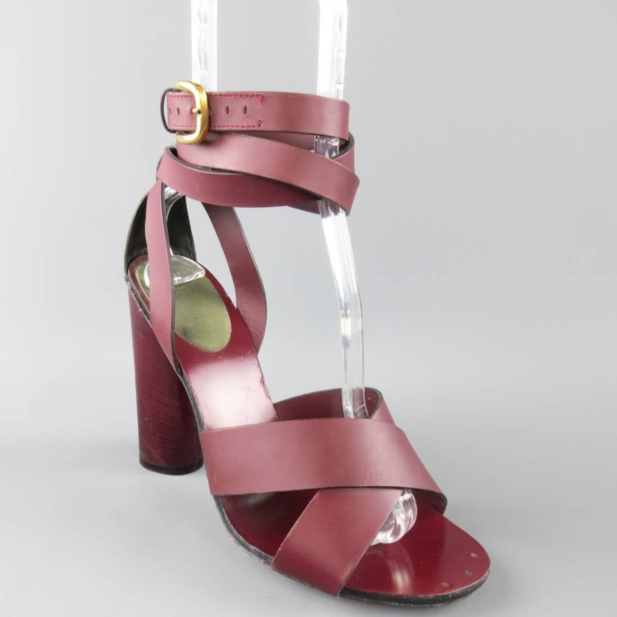 These fabulous retro inspired GUCCI sandals come in burgundy red leather and feature a thick X strap, olive suede heel, wrapped ankle strap with gold tone buckle, and chunky stacked heel. Wear throughout. As-Is. Made in Italy.
 
Fair Pre-Owned