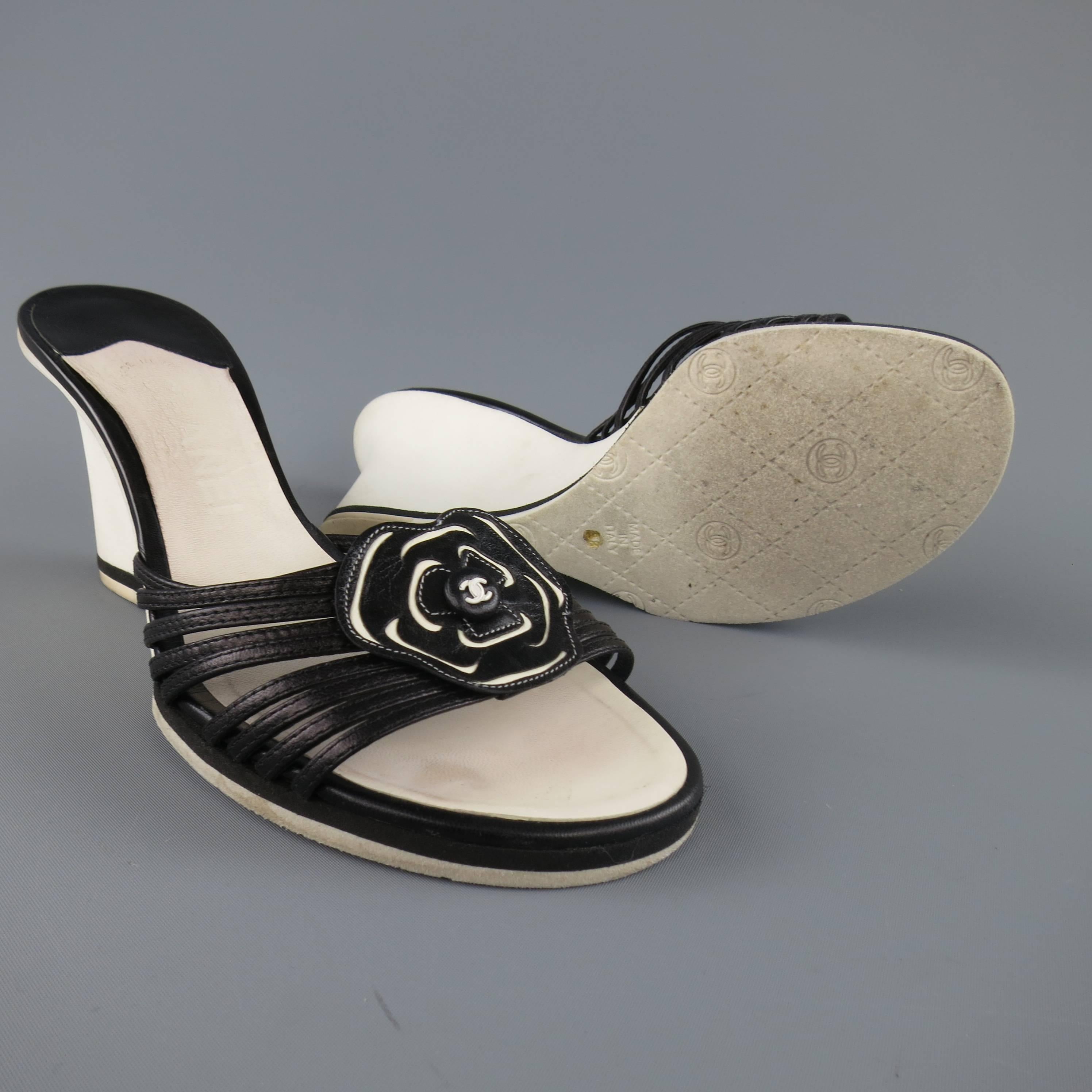 Vintage CHANEL sandals feature a strappy toe with signature camellia logo flower and white leather wedge heel. Wear throughout. As-Is. Made in Italy.
 
Fair Pre-Owned Condition.
Marked: IT 38
 
Heel: 3.25 in.


Web ID: 82510 