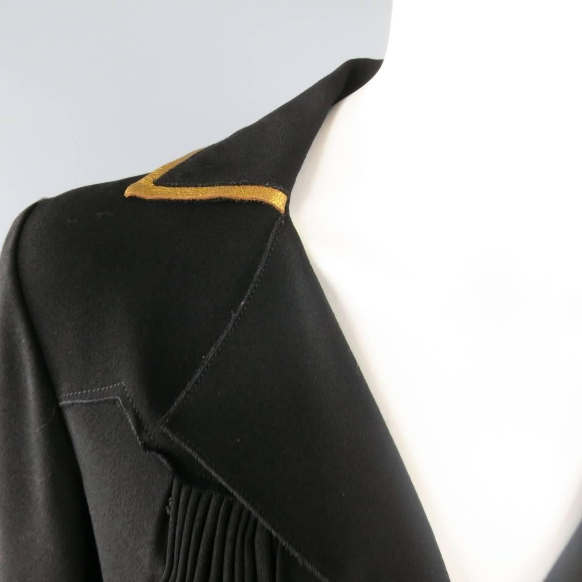 PRADA shirt jacket in a black crepe material featuring a pointed lapel collar, raw edge decorative shoulder panel, gathered pleat bust and waist, patch pockets, hidden snap closure, and gold leather trim throughout. Thread through pleats coming