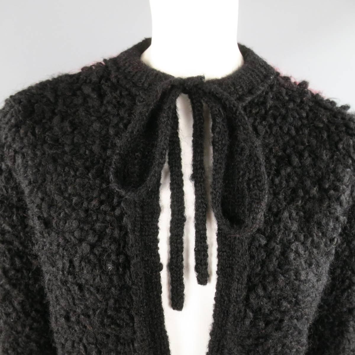 Vintage SONIA RYKIEL cardigan jacket comes in black fuzzy textured wool and features a crewneck, frontal pockets, double tie closure, and red color block panel back. Made in Italy.
 
Good Pre-Owned Condition.
Marked: IT 36
 
Measurements:
