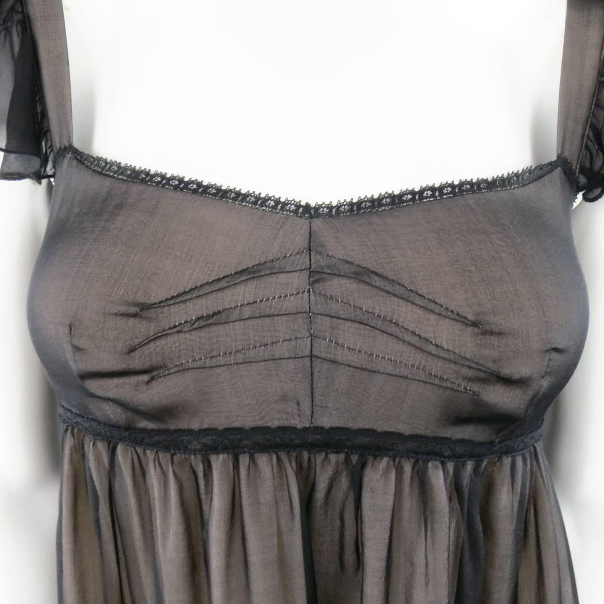 D&G by DOLCE & GABBANA lingerie inspired camisole blouse comes in black sheer chiffon with beige liner and features a ruffled cap sleeve, darted bust, empire waist with lace trim, A-line silhouette with raw edge ruffle panel, and long fringe
