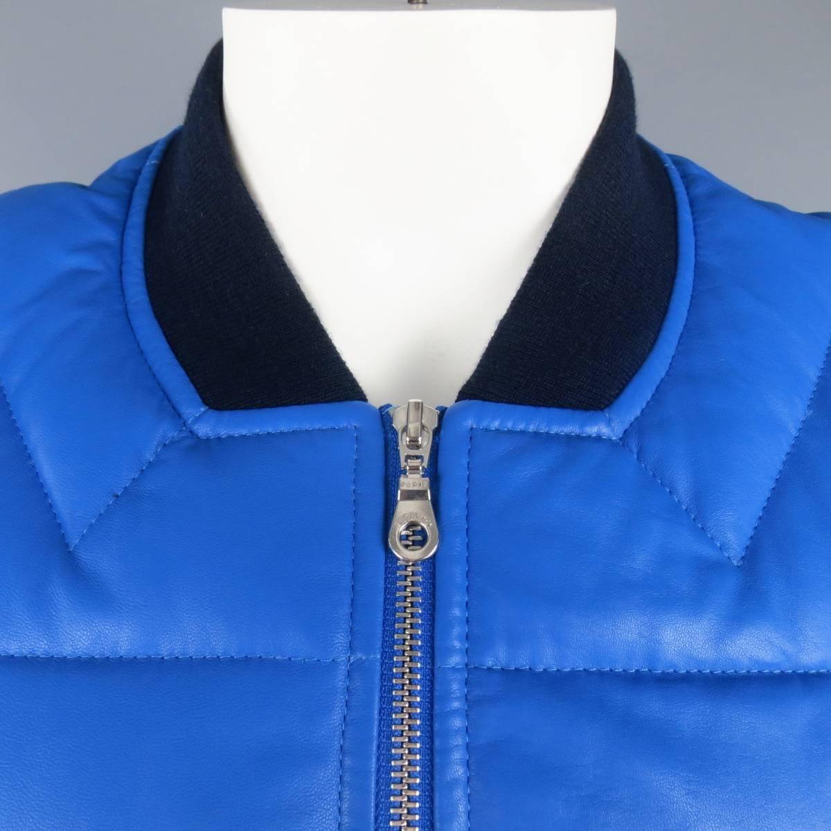 KENZO bomber style jacket in a vibrant blue chevron quilted lambskin leather featuring slanted snap pockets, ribbed sides, and navy knit collar and cuffs. Minor imperfections in leather. As-Is. Made in  Romania.
 
New with Tags. Retails at