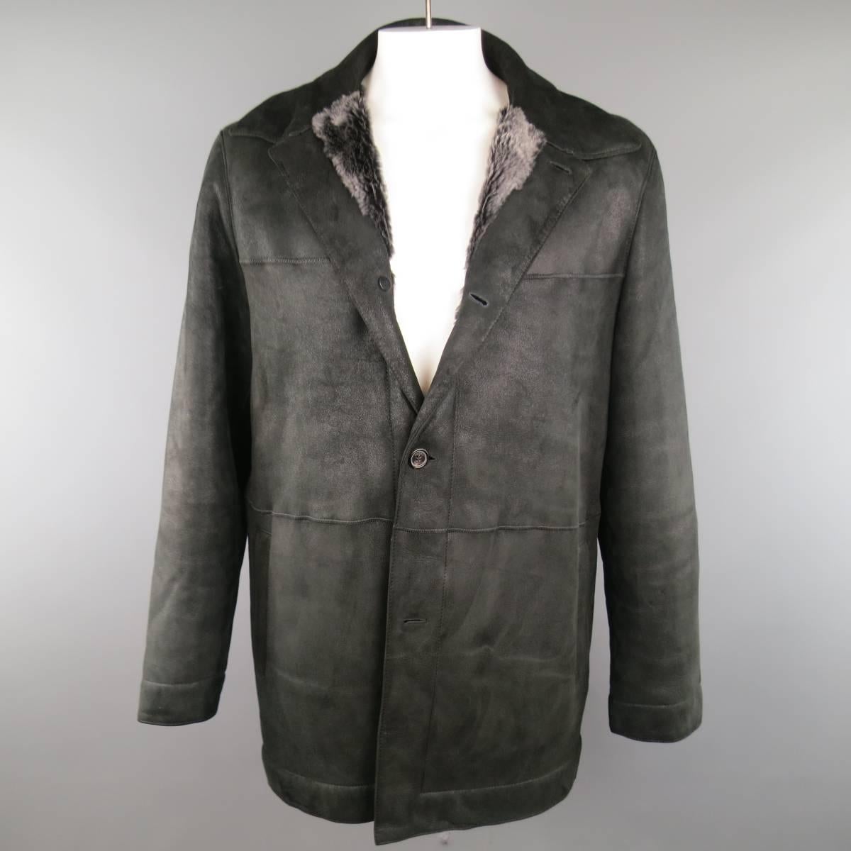 Classic PRADA button up coat in a soft black shearling featuring a sueded exterior with pointed collar and slanted pockets with dyed fur lining. Wear throughout. As-Is. Made in Italy.
 
Good Pre-Owned Condition.
Marked: 56
 
Measurements:
