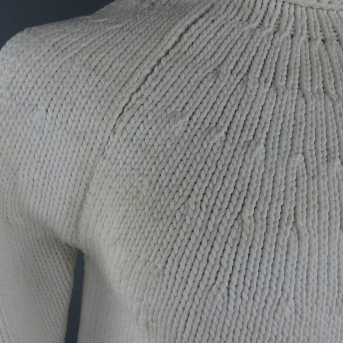 Vintage YOHJI YAMAMOTO oversized pullover sweater comes in a rigid, starched off white knit and features a mock crew neck, raglan sleeves, and rolled hems. Discolorations throughout. As-Is. Made in Japan.
 
Fair Pre-Owned Condition.
Marked: M
