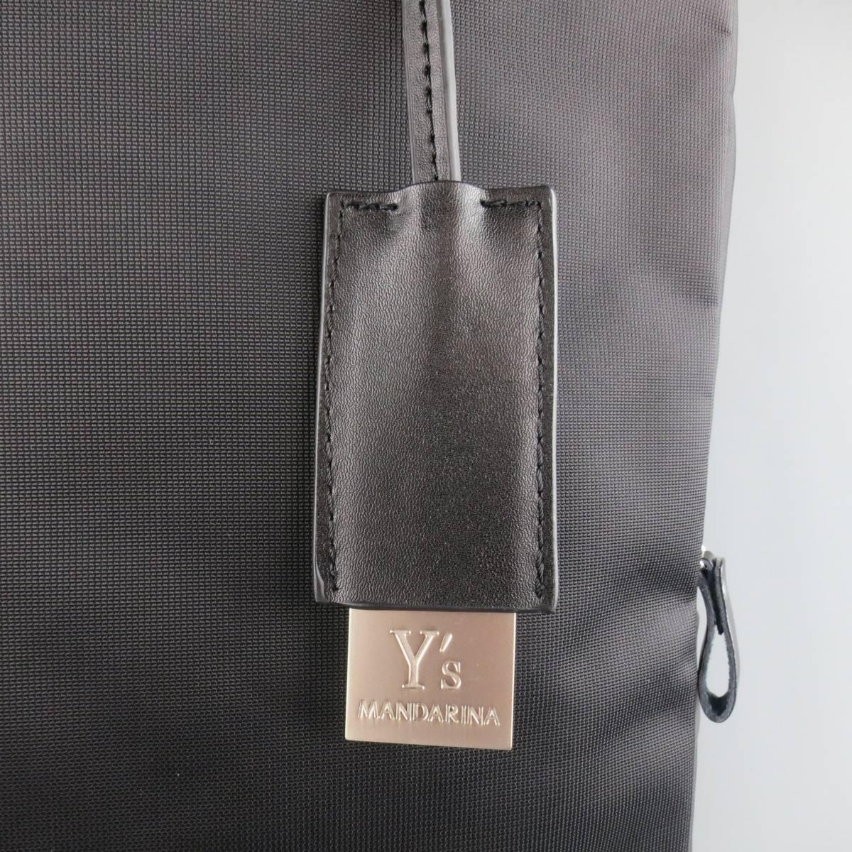 Y's YOHJI YAMAMOTO MANDARINA tote bag in a black nylon featuring a rectangular shape, double webbing top handles, metal tag, frontal zip compartment with leather tag, optional crossbody shoulder strap, and internal double snap sections.
 
Excellent