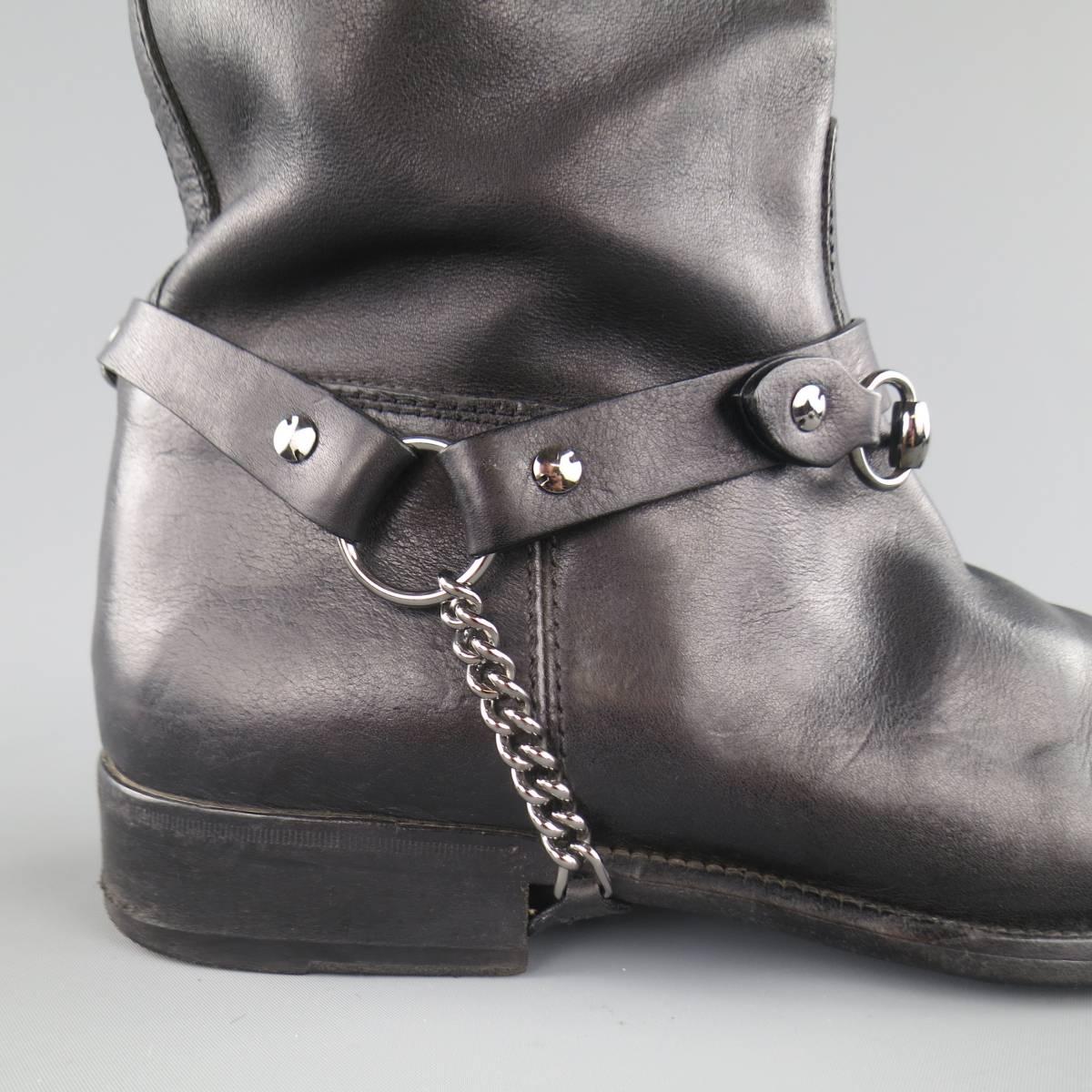 GUCCI knee high biker boots come in black leather and feature a round toe, internal red and green stripe web pulls, and leather chain ankle harnesses with horsebit detail that can be worn both ways. Made in Italy.
 
Good Pre-Owned Condition.
Marked: