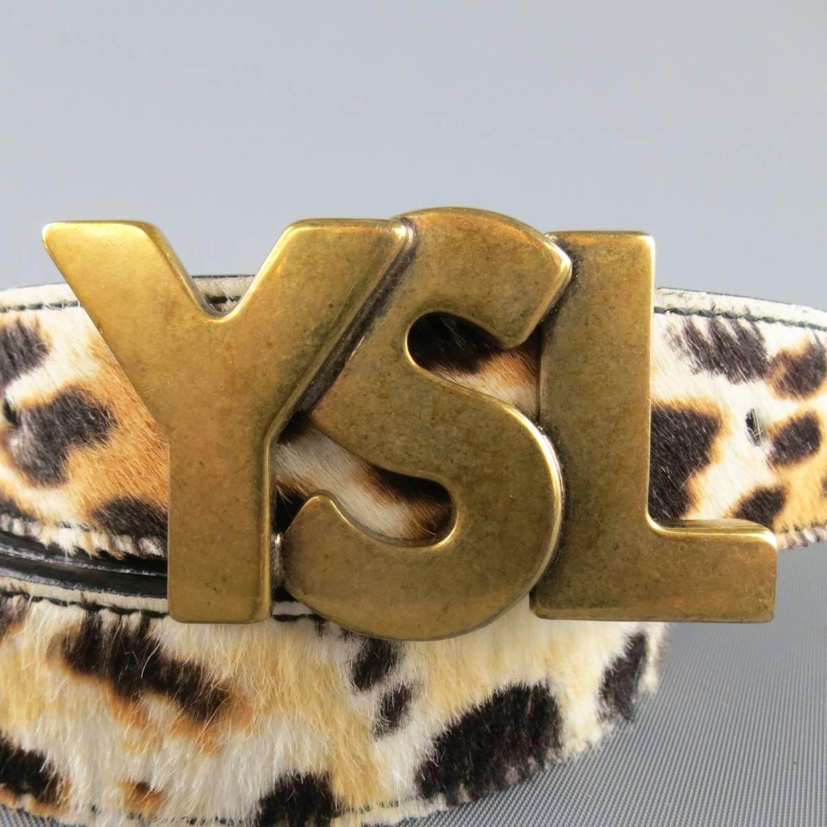 Retro inspired YVES SAINT LAURENT by TOM FORD belt features a cream cheetah leopard print pony hair skinny strap and dark gold tone YSL logo brass buckle. Wear throughout.  Made in Italy.
 
Good Pre-Owned Condition.
Marked: 40
 
Length: 45