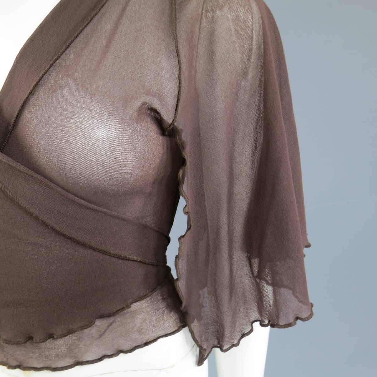 This fabulous JEAN PAUL GAULTIER top comes in a gorgeous brown stretch micro mesh and features a deep v neckline, wrap and tie closure, and open ruffled hem, capelet sleeves. Made in Italy.
 
Excellent Pre-Owned Condition.
Marked: M
 
Measurements:
