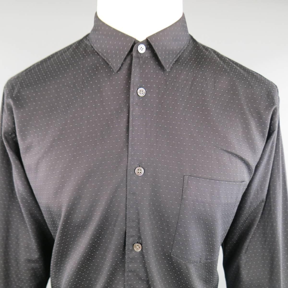 COMME des GARCONS shirt in comes in a dotted, textured black cotton and features a pointed collar, breast pocket, and polka dot bottom panel. Wear throughout. Made in France.
 
Good Pre-Owned Condition.
Marked: M W22039
 
Measurements:
 
Shoulder: