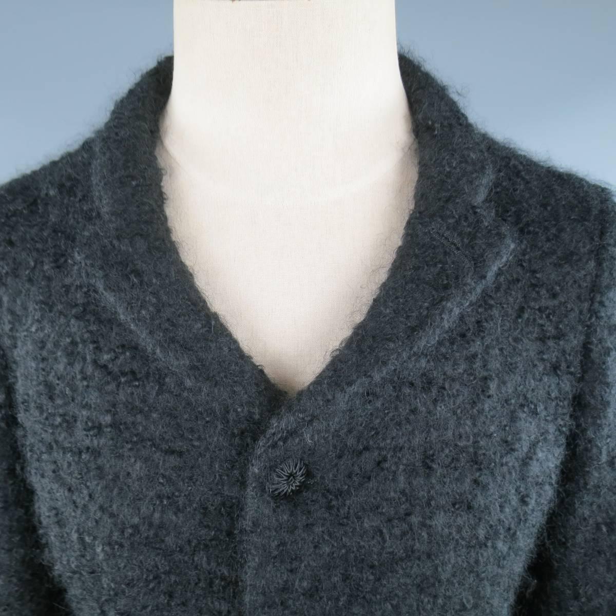 COMME des GARCONS HOMME PLUS jacket comes in a fuzzy textured mohair wool fabric and features a small notch lapel, three button closure, flap pockets, and half lined interior. Minor wear throughout. Made in Japan.
 
Good Pre-Owned Condition.
Marked: