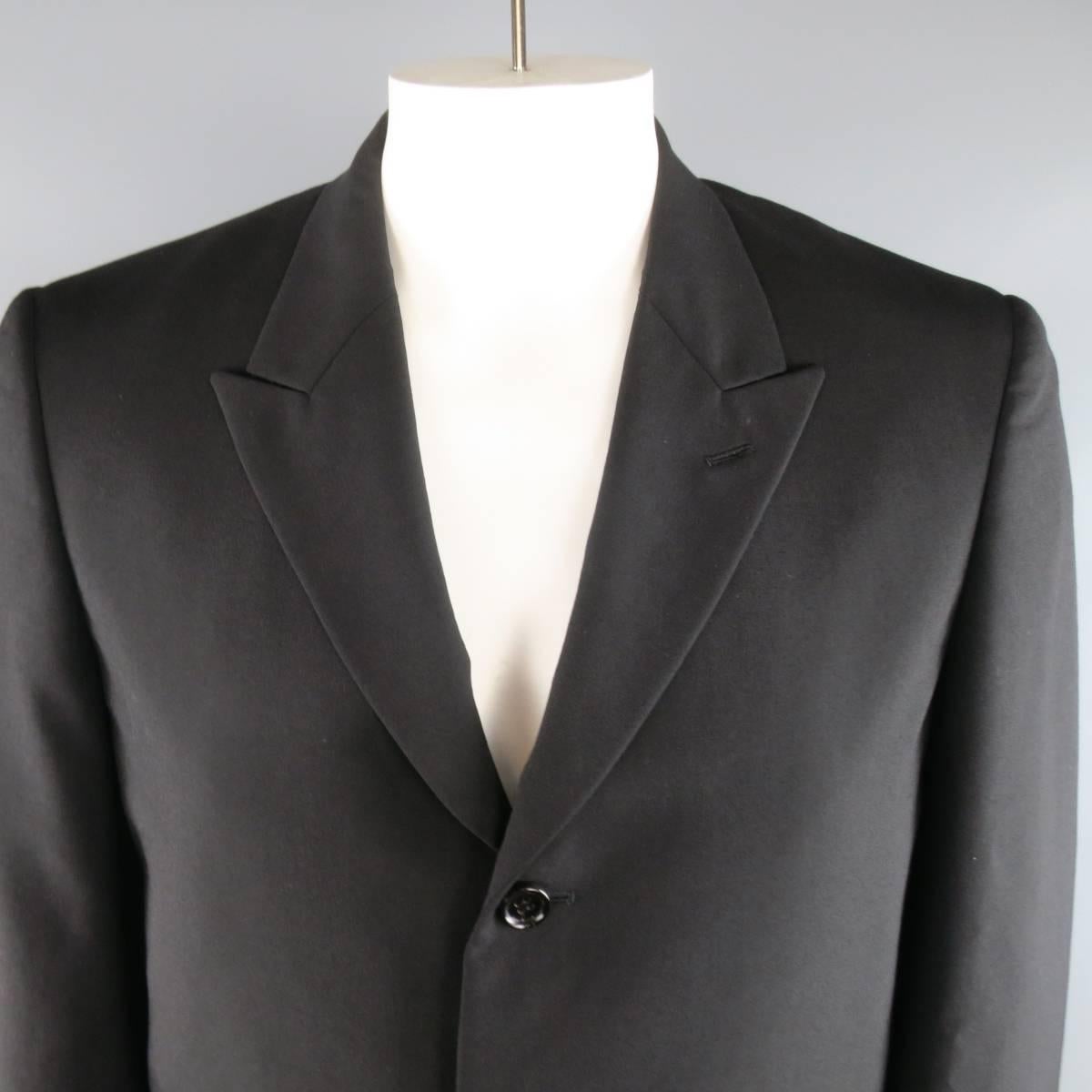 COMME des GARCONS HOMME PLUS sport coat comes in a light weight black wool and features a boxy silhouette, peak lapel, three button closure, and metallic gold and striped liner. Wear it inside out for a runway to street effect. Made in Japan.
