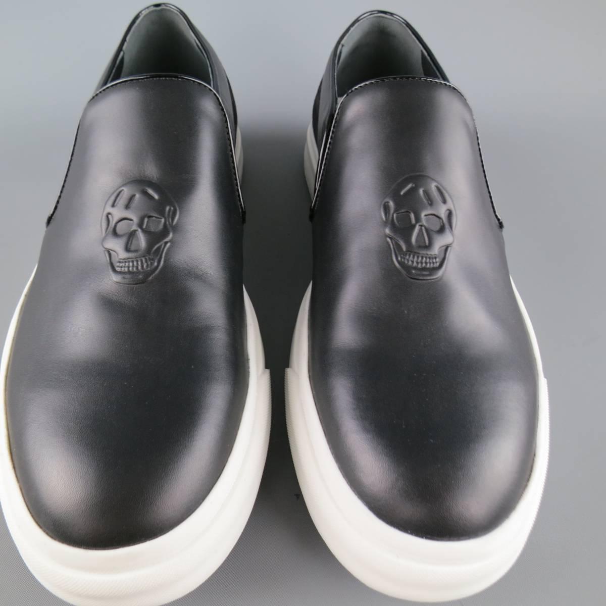 ALEXANDER MCQUEEN slip on sneakers come in smooth black leather and feature patent leather piping, embossed skull logo, embroidered suede back panel, and thick white rubber sole. With box. Made in Italy.
 
New in Box.
Marked: 42
 
Outsole: 11.75 x