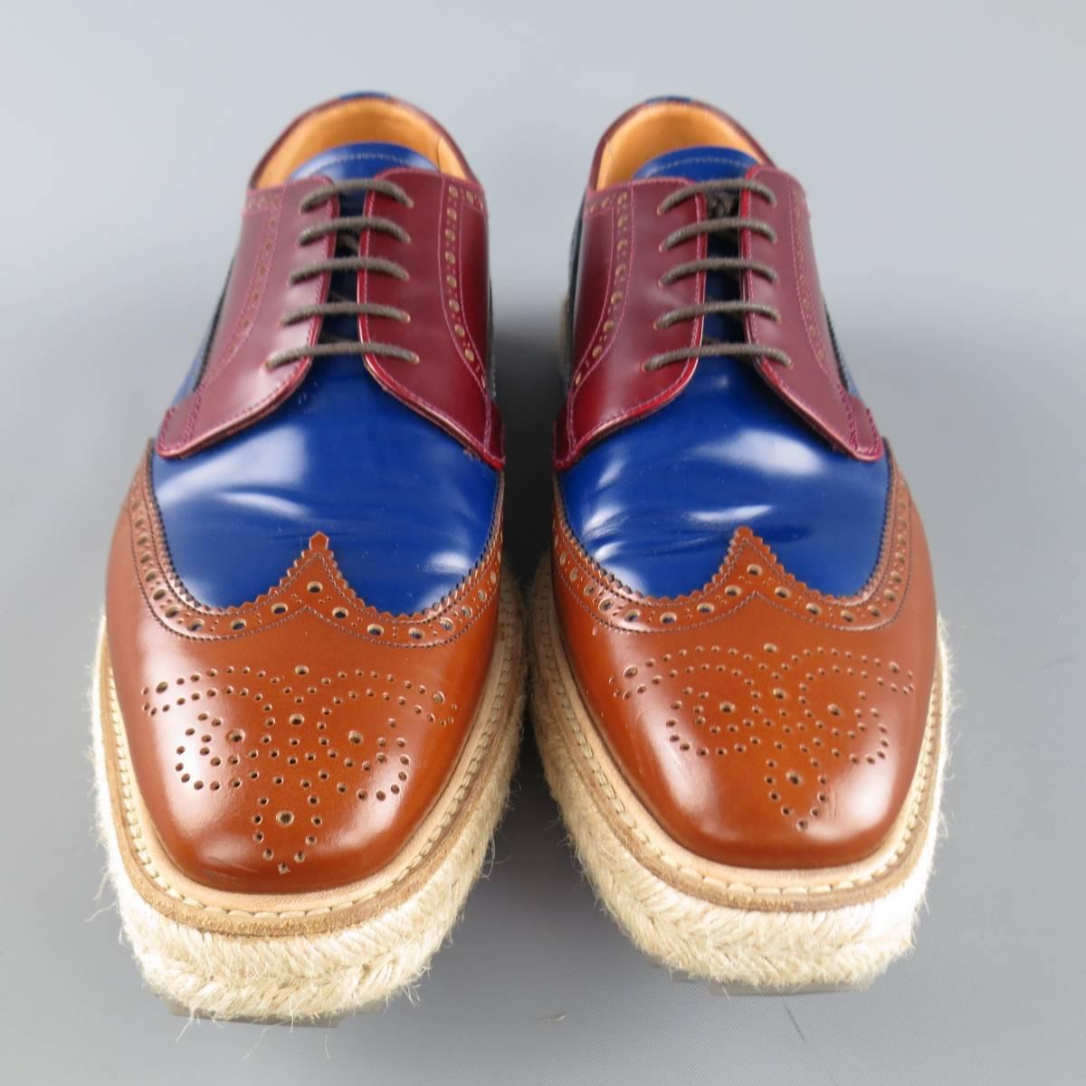 Iconic Spring Summer 2011 Collection PRADA brogues come in burgundy, navy blue, and tan color block leather and feature a wingtip, perforated brogue details, and thick braided espadrille sole.  With box. Made in Italy.
 
Excellent Pre-Owned