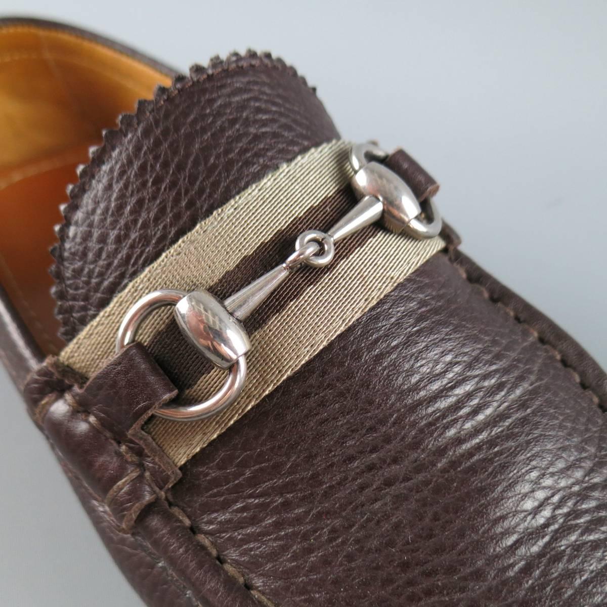GUCCI loafers come in a rich chocolate brown pebbled leather and feature an apron toe with stripped webbing strap. silver tone horsebit detail, and driver sole. With box. Made in Italy.
 
Excellent Pre-Owned Condition.
Marked: 7.5
 
Outsole: 11 x 4