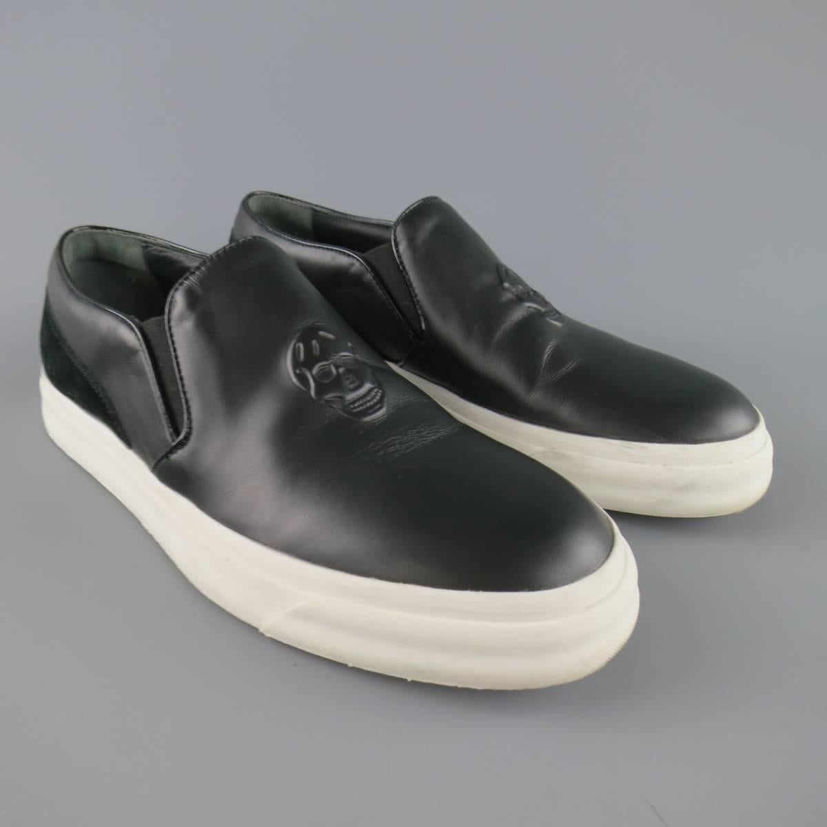 ALEXANDER MCQUEEN slip on sneakers come in smooth black leather and feature patent leather piping, embossed skull logo, embroidered suede back panel, and thick white rubber sole. With box. Made in Italy.
 
Good Pre-Owned Condition.
Marked: 42

