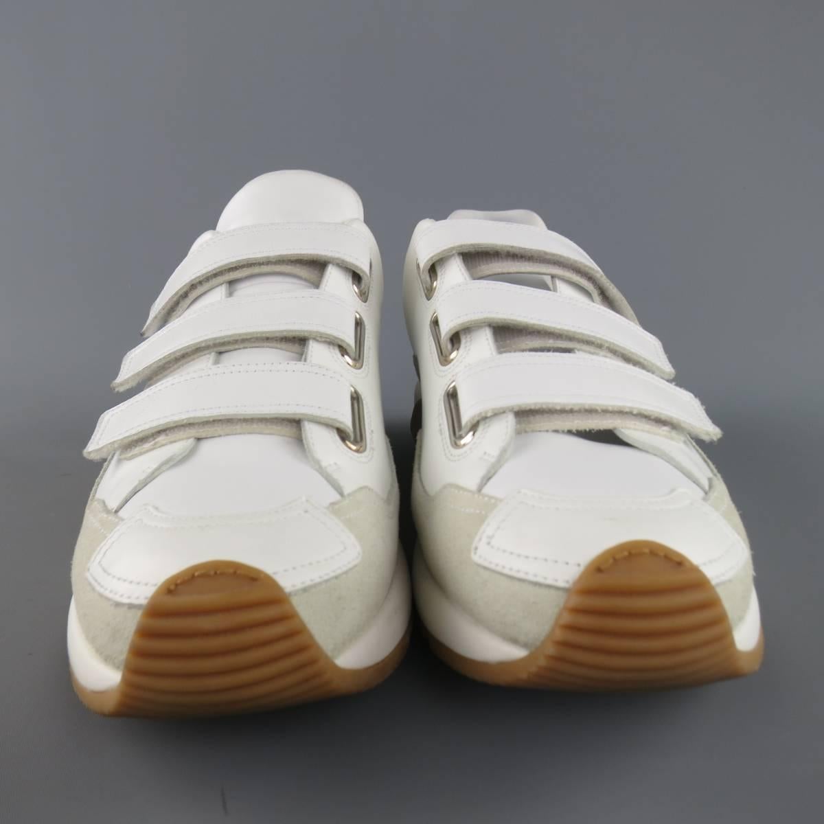 DIOR HOMME runway sneakers consists of leather material in a white color tone. Designed in a round-toe front, velcro strap vamp-closure with tone-on-tone stitching along edges. Detailed with suede trim along sides in a light beige color and tan