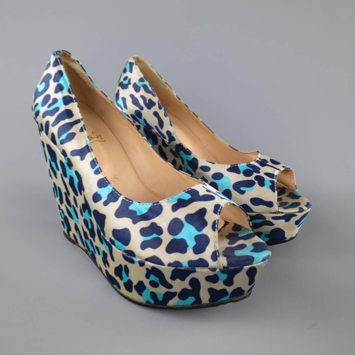 CHRISTIAN LOUBOUTIN pumps come in a beige and blue cheetah print silk satin and feature a peep toe and platform covered wedge. Made in Italy.
 
Good Pre-Owned Condition.
Marked: IT 39
 
Heel:4.25 in.
Platform:  1.5 in.


Web ID: 81401 