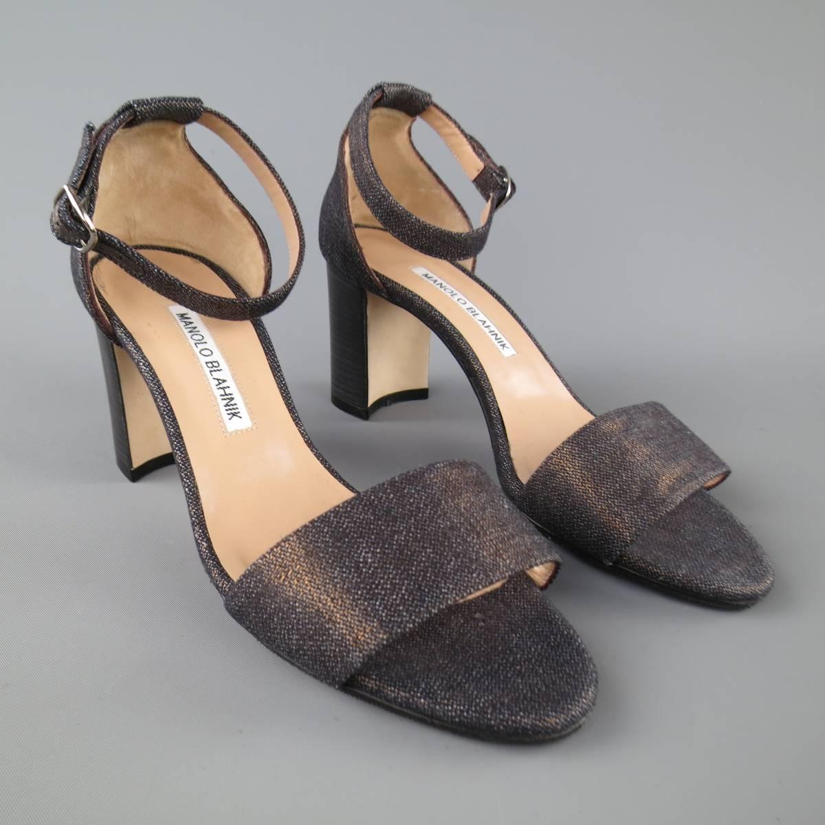 MANOLO BLAHNIK casual sandals come in a dark navy denim with bronze metallic sheen and feature a thick toe strap, ankle strap, and chunky, stacked heel. Made in Italy.
 
Excellent Pre-Owned Condition.
Marked: 36.5
 
Heel: 2.75 in.


Web ID: 82814 
