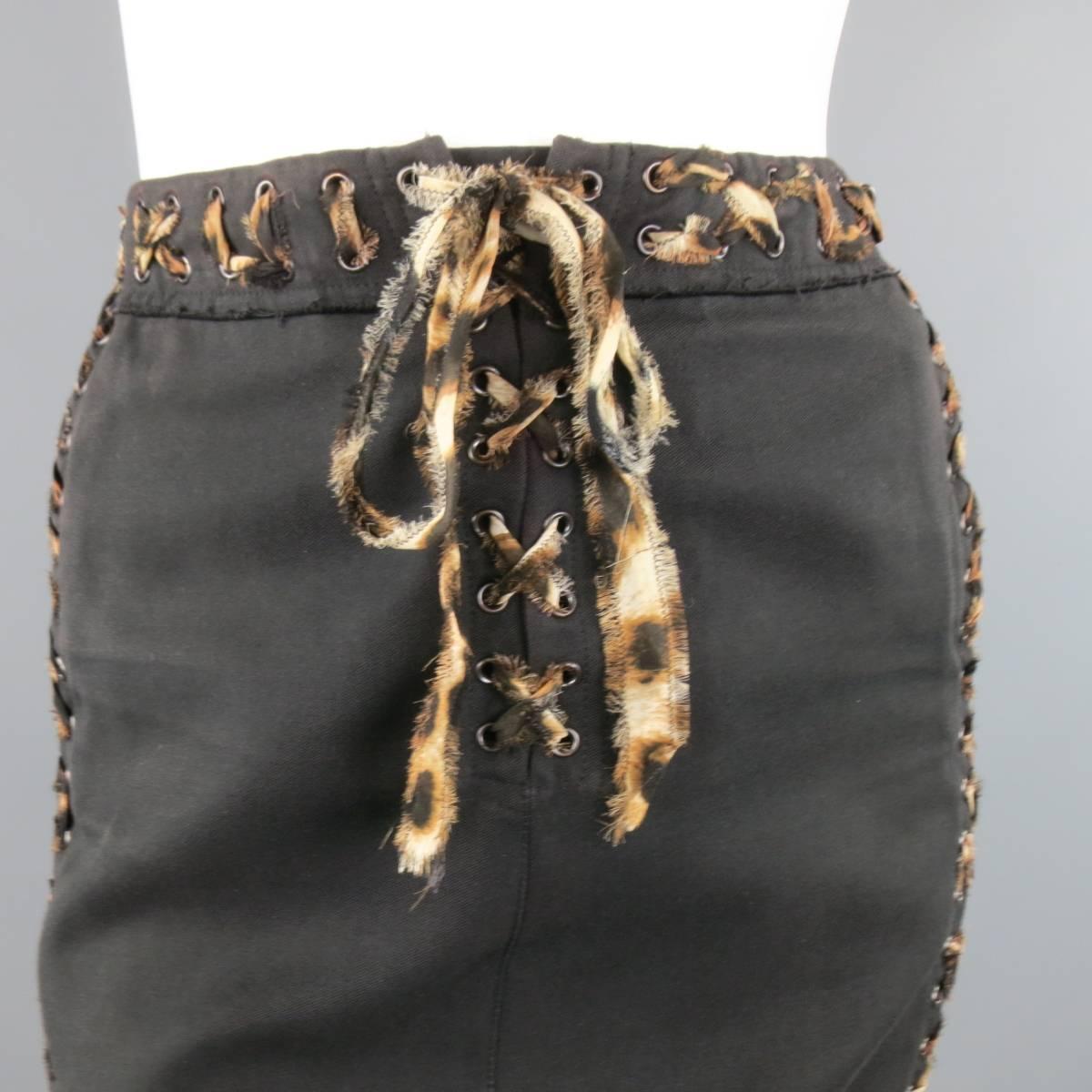 This fabulous pencil skirt from YVES SAINT LAURENT Spring 2002 Collection by TOM FORD comes in a deep chocolate taupe brown twill and features a raw edge waist band, lace up frontal closure, and grommet piping with leopard silk chiffon laced