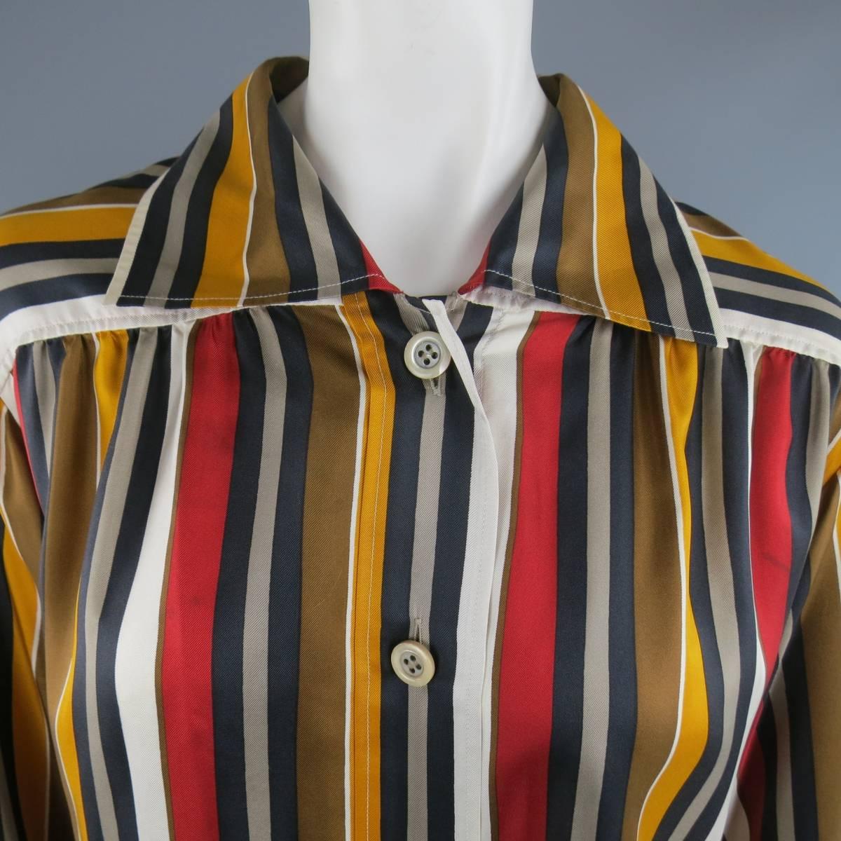 Vintage SAINT LAUENT Rive Gauche blouse comes in a gold, red, black, and white striped silk twill and features a spread collar, blousey sleeves, and gathered boxy silhouette. Wear and discolorations throughout fabric. As-Is. Made in France.
 
Fair