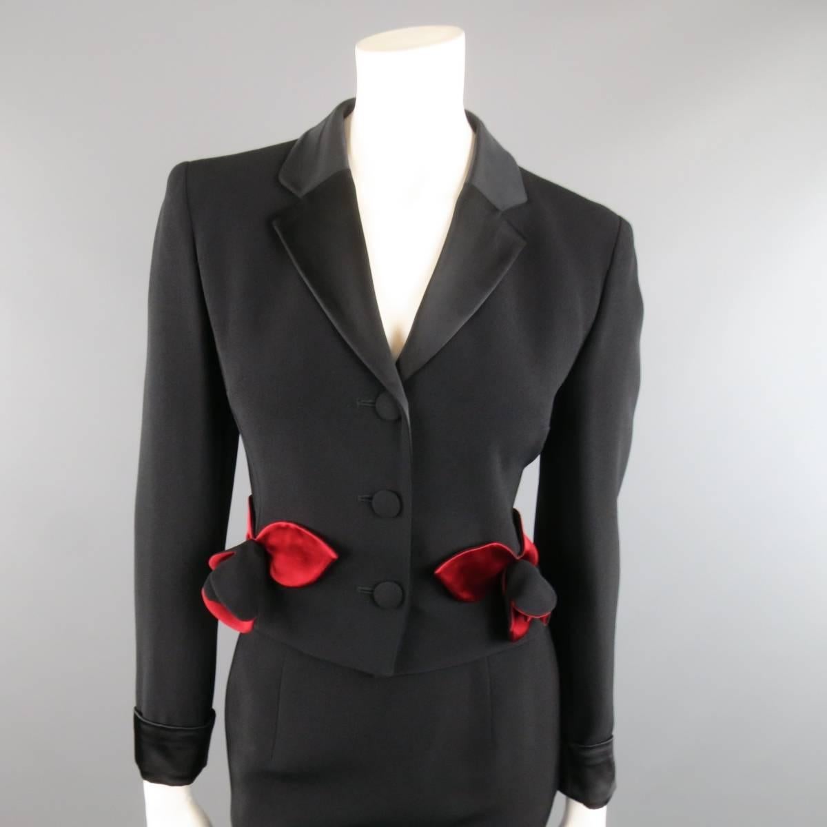 Vintage MOSCHINO Cheap & Chic suit comes in black crepe and includes a cropped jacket with satin lapel and cuffs, three button closure, and red satin rose appliques at waist with matching skirt. Made in Italy.
 
Good Pre-Owned Condition.
Marked: 8
