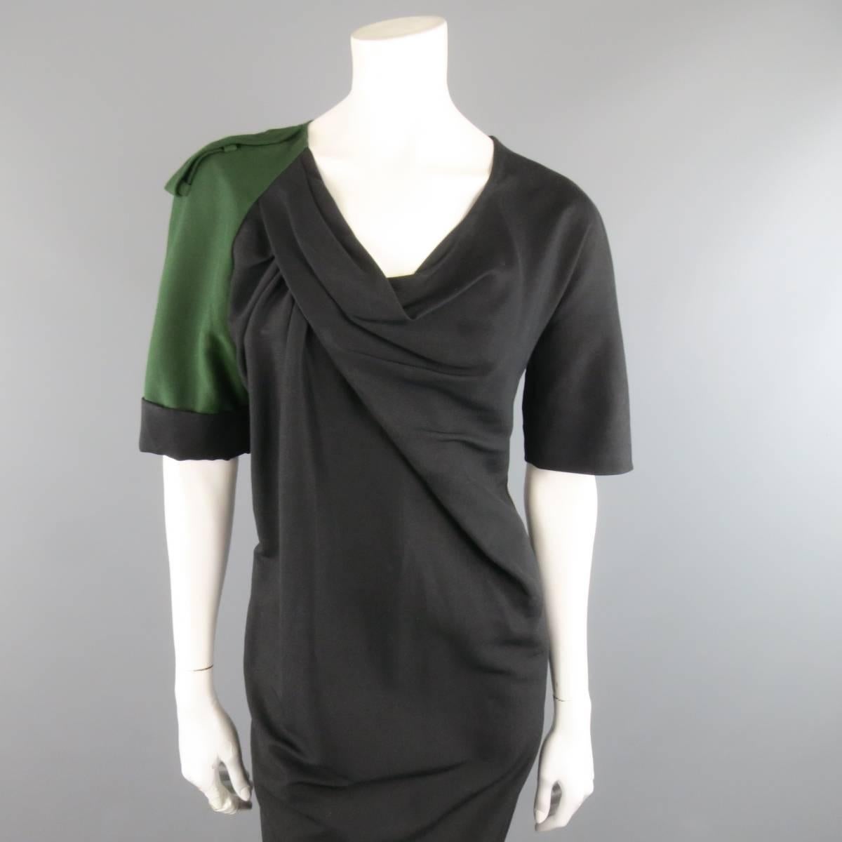 This avante garde DRIES VAN NOTEN dress comes in a black cotton silk blend twill and features an asymmetrical draped scoop neck, shift silhouette, side panel, and green epaulet cuffed military sleeve. Minor wear. Made in Belguim.
 
Good Pre-Owned