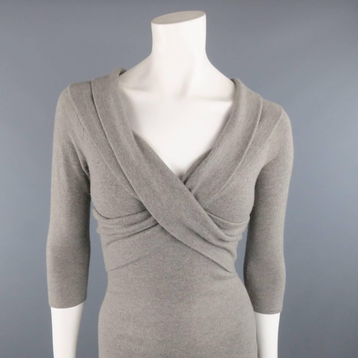 RALPH LAUREN BLACK LABEL fitted sheath sweater dress comes in a light silver gray stretch cashmere knit and features a folded collar, three quarter sleeves, and wrap detailed front. Fabulous off the shoulder.
 
Good Pre-Owned Condition.
Marked: S
