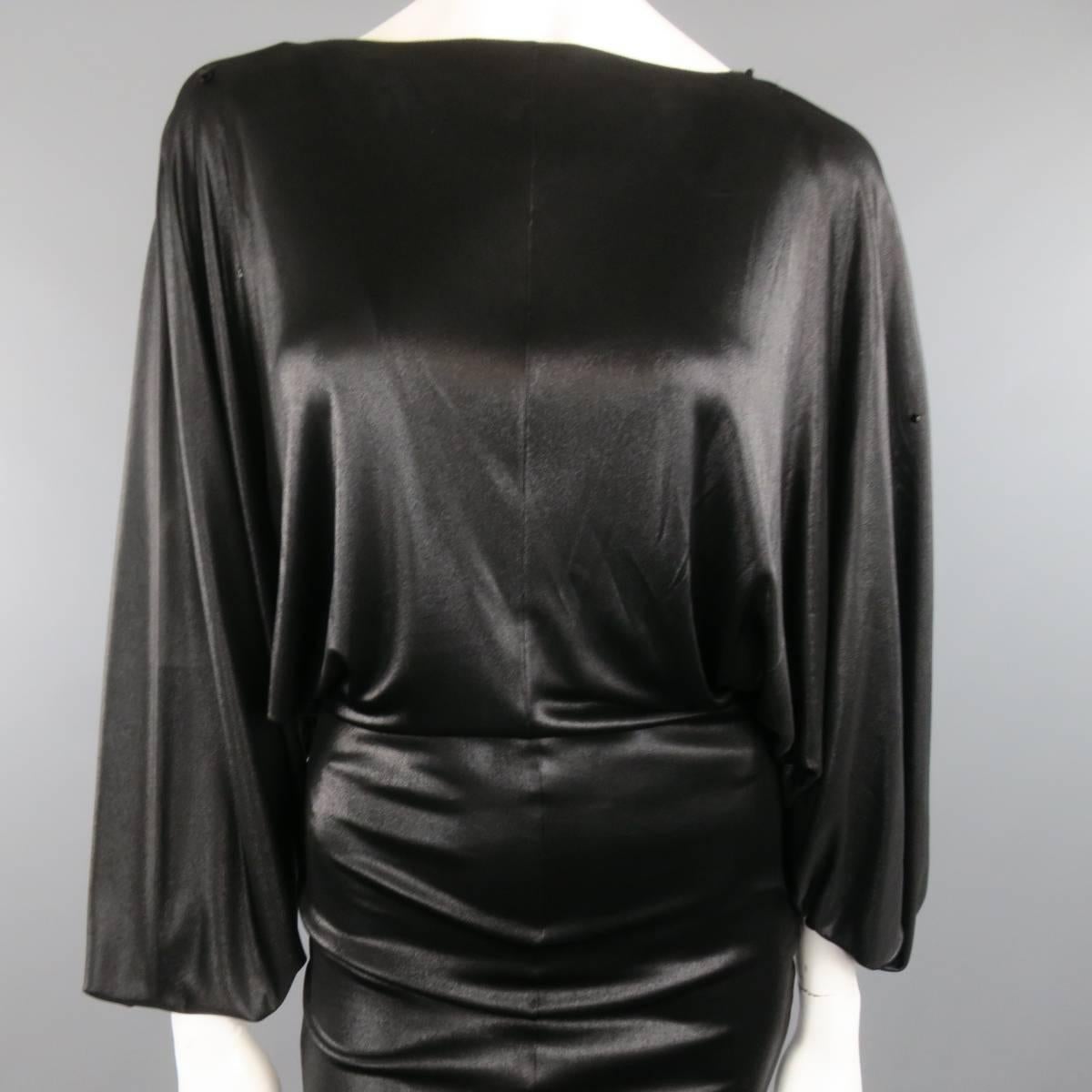This rare MAISON MARTIN MARGIELA (blank nameless tag) cocktail dress comes in a light weight shiny black stretch lame' and features a high neckline, extra long batwing sleeves, crystal beaded shoulders, and fitted silhouette. Imperfections on beaded