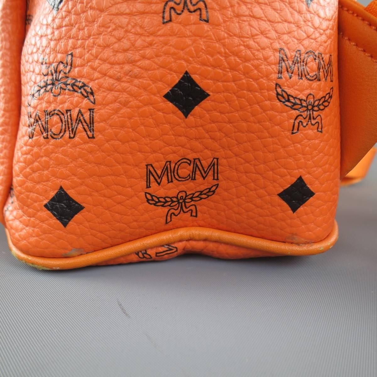 MCM Orange Monogram Coated Canvas Studded Backpack In Good Condition In San Francisco, CA