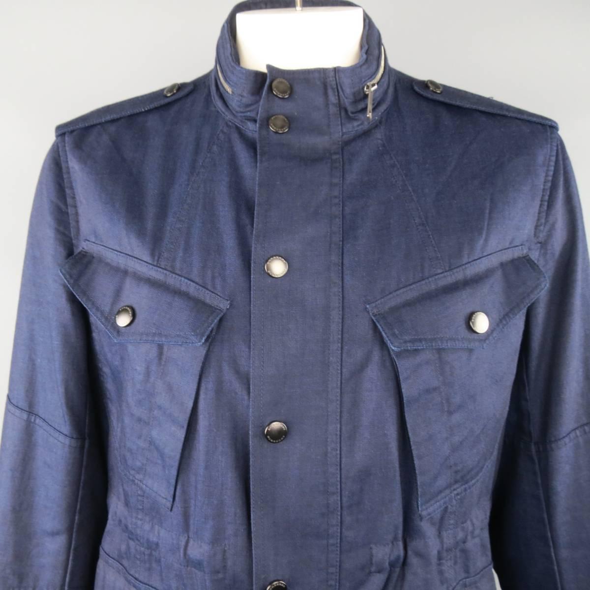 BURBERRY BRIT military inspired parka jacket comes in a light weight indigo navy blue cotton and features a zip closure with hidden snap placket, parch flap pockets, epaulets, drawstring waist and hem, and high collar with zip out hood.
 
New with