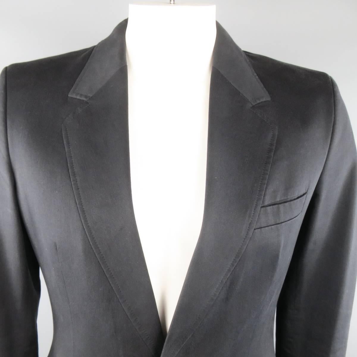MAISON MARTIN MARGIELA sport coat comes in a soft black cotton blend twill chino fabric and features a sewn down, flat notch lapel, single hidden hook closure with simulated buttons, and simulated button cuffs. Made in Italy.
 
Excellent Pre-Owned