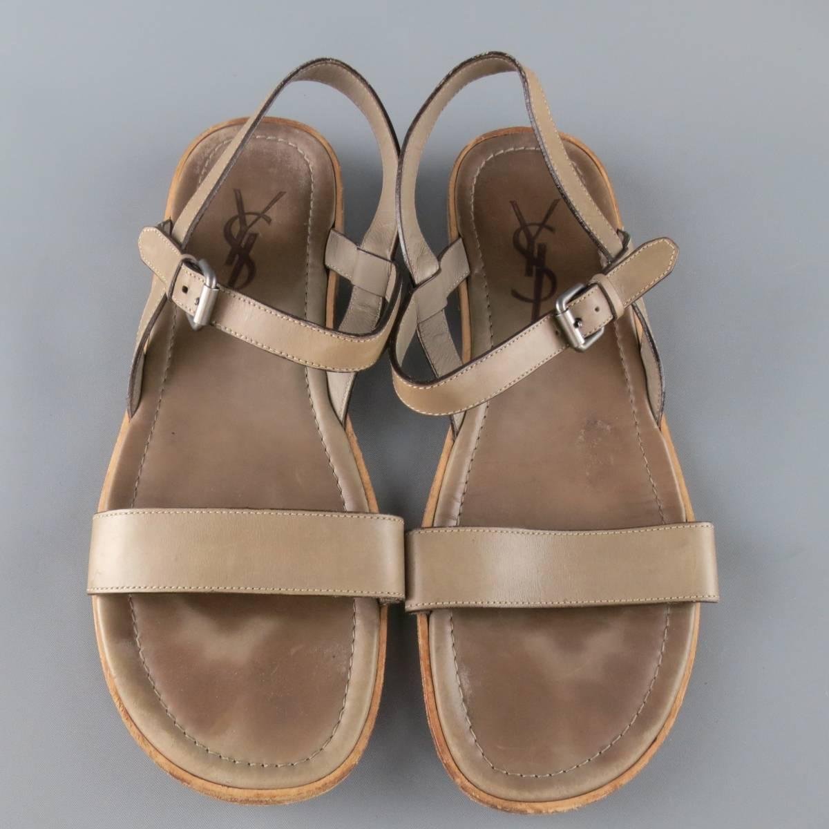 YVES SAINT LAURENT sandals feature light taupe gray leather toe strap and ankle harness with a logo leather insole and stacked sole. Resoled. Wear throughout. As-Is. Made in Italy.
 
Fair Pre-Owned Condition.
Marked: 44.5


Web ID: 82685 