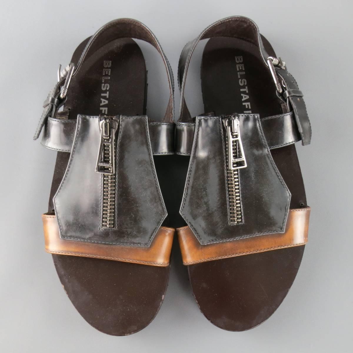 BELSTAFF sandals come in two tone distressed look tan and charcoal patent leather and feature a thick geometric patchwork statement front with gunmetal tone zipper and back strap with buckle. Made in Italy.
 
Good Pre-Owned Condition.
Marked:
