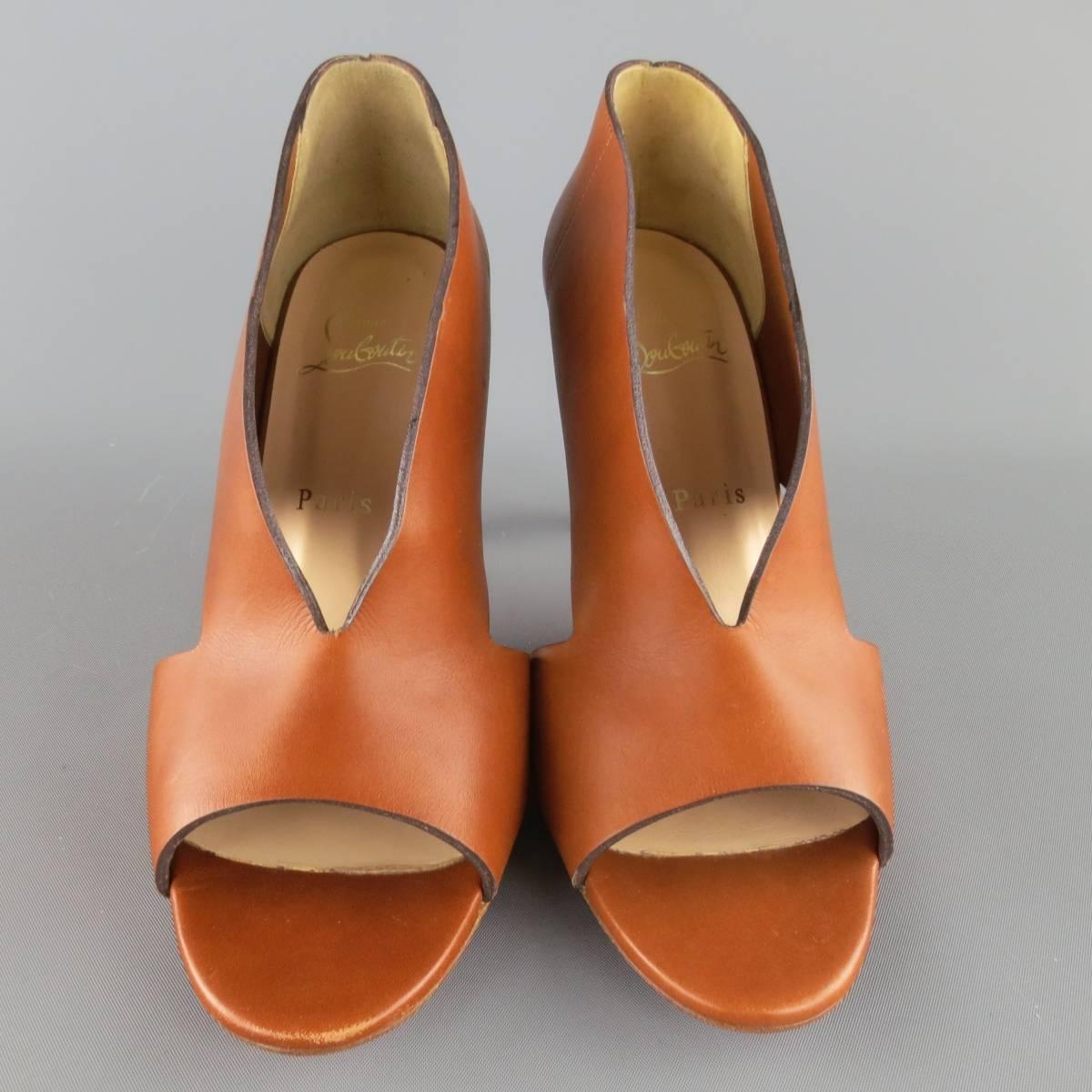 CHRISTIAN LOUBOUTIN booties come in tan brown leather and feature a peep toe, side cutouts, and stacked stiletto heel. Never Worn. Made in Italy.
 
Excellent Pre-Owned Condition.
Marked: IT 39
 
Heel: 3.5 in.


Web ID: 83513 