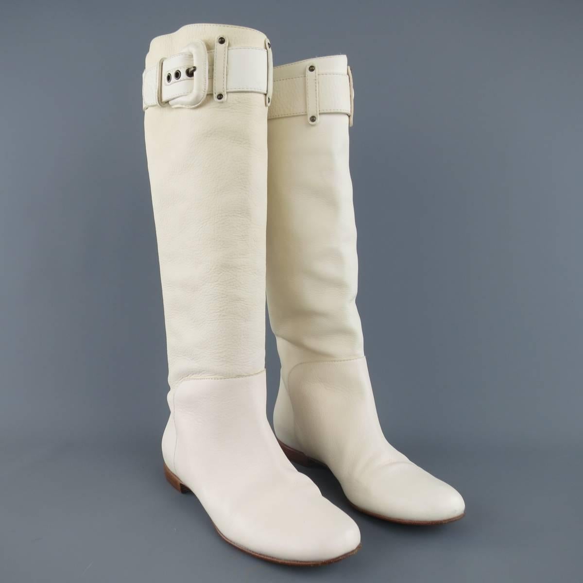 Vintage GIUSEPPE ZANOTTI boots come in cream leather and feature a round toe, tall shaft and leather covered buckle strap detail. Variations in tone and texture throughout leather. Made in Italy.
 
Good Pre-Owned Condition.
Marked: IT 37
