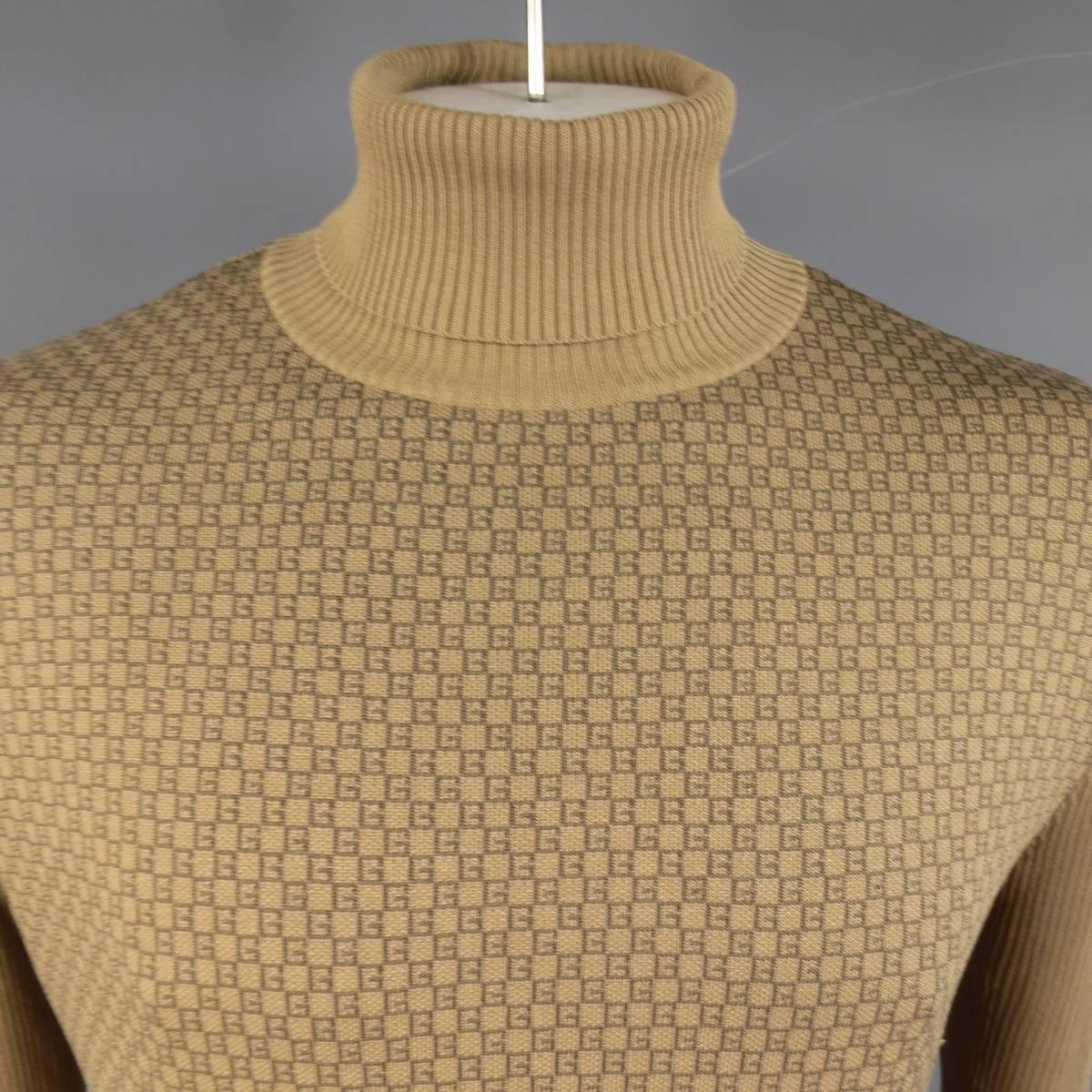 Golden tan khaki ribbed silk print turtleneck sweater by GUCCI featuring a frontal brown G monogram print panel. Made in Italy.
 
Excellent Pre-Owned Condition.
Marked: L
 
Measurements:
 
Shoulder: 21 in.
Chest: 48 in.
Sleeve: 27 in.
Length: 28