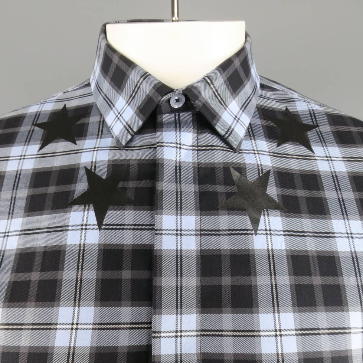 GIVENCHY by Riccardo Tisci dress shirt comes in a light blue and black plaid cotton twill and features a pointed collar, button up closure with hidden placket, and ring of stars around collar. Made in Portugal.
 
Excellent  Pre-Owned