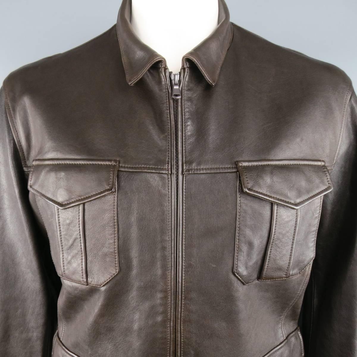 Brunello Cucinelli military style jacket comes in soft and smooth rich chocolate brown leather and features a pointed collar, tonal double zip closure, burgundy windbreaker liner, and patch flap pockets. Made in Italy.  Retailed at $6340.00
 
New