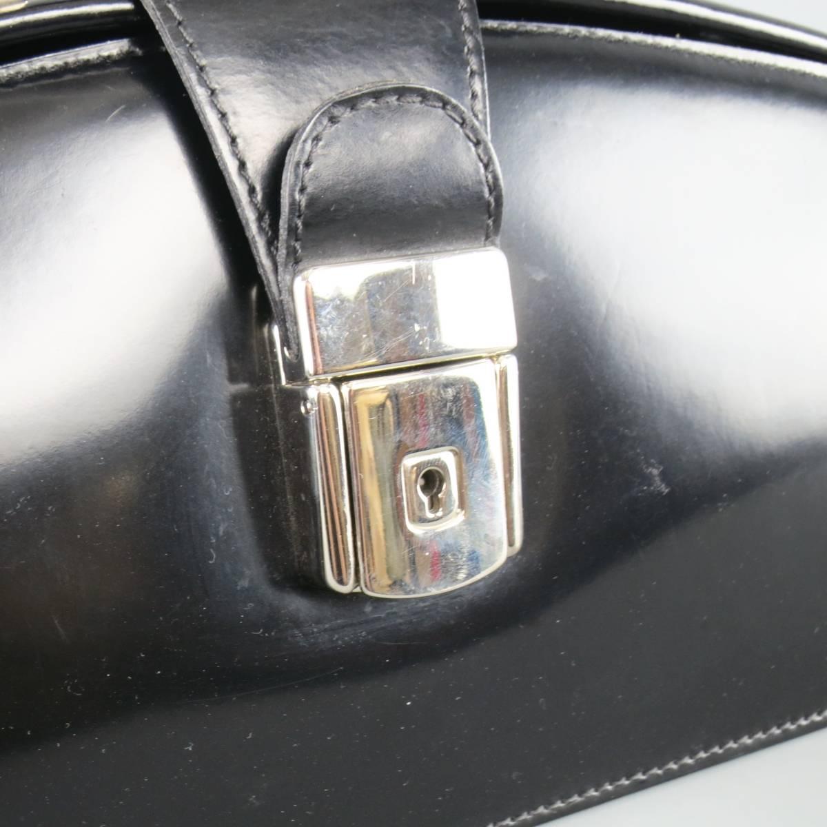 Vintage PRATESI mini doctor's bag comes in shiny black leather and features a covered top handle, silver tone buckle lock closure, and gold interior. Made in Italy.
 
Good Pre-Owned Condition.
 
Measurements:
 
Length: 10.75 in.
Width: 4.25