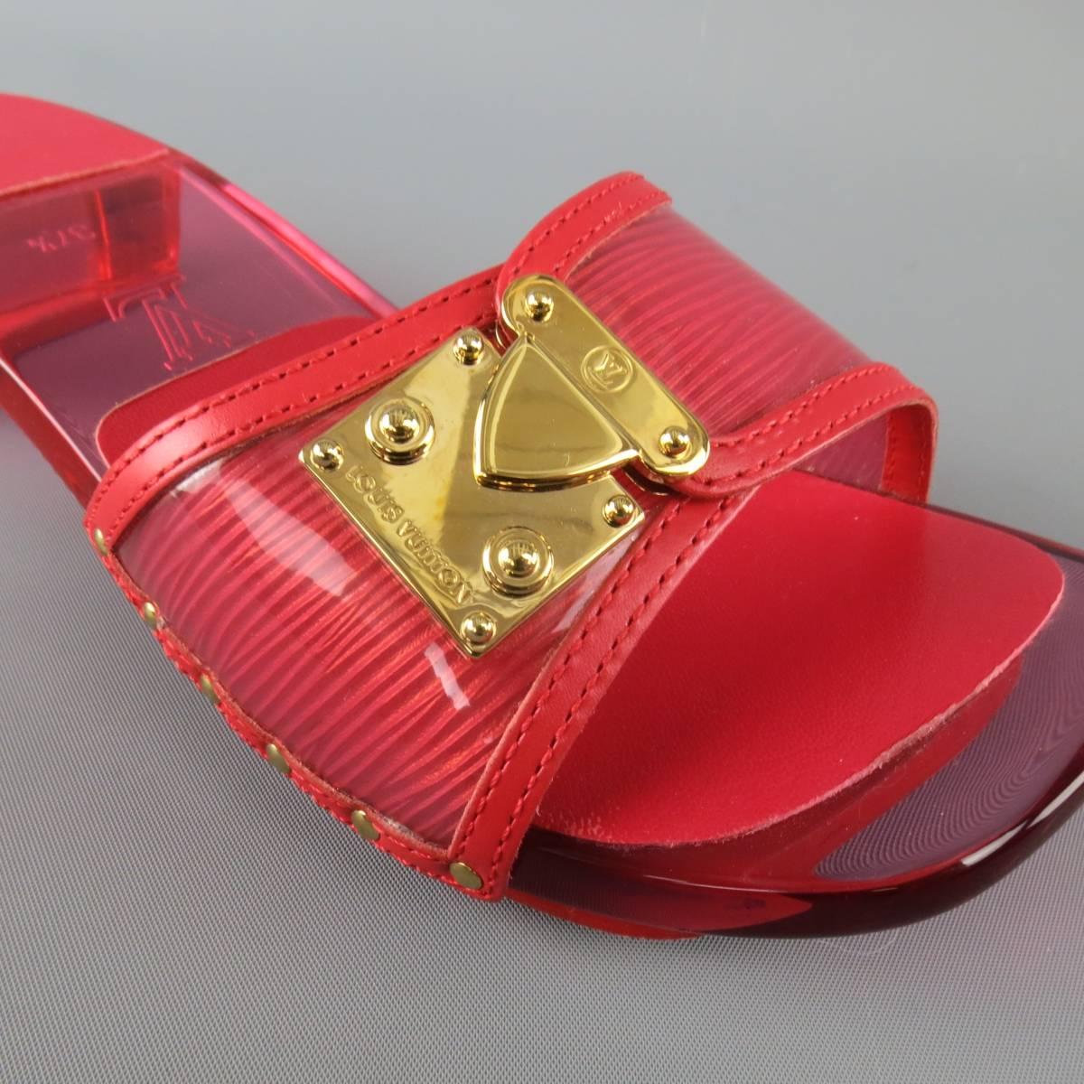 LOUIS VUITTON sandals feature a vinyl overlay Epi leather strap with gold tone buckle detail and clear sole and block heel. Made in Italy.
 
Excellent Pre-Owned Condition.
Marked: IT 37.5
 
Heel: 1.45 in.


Web ID: 83181 