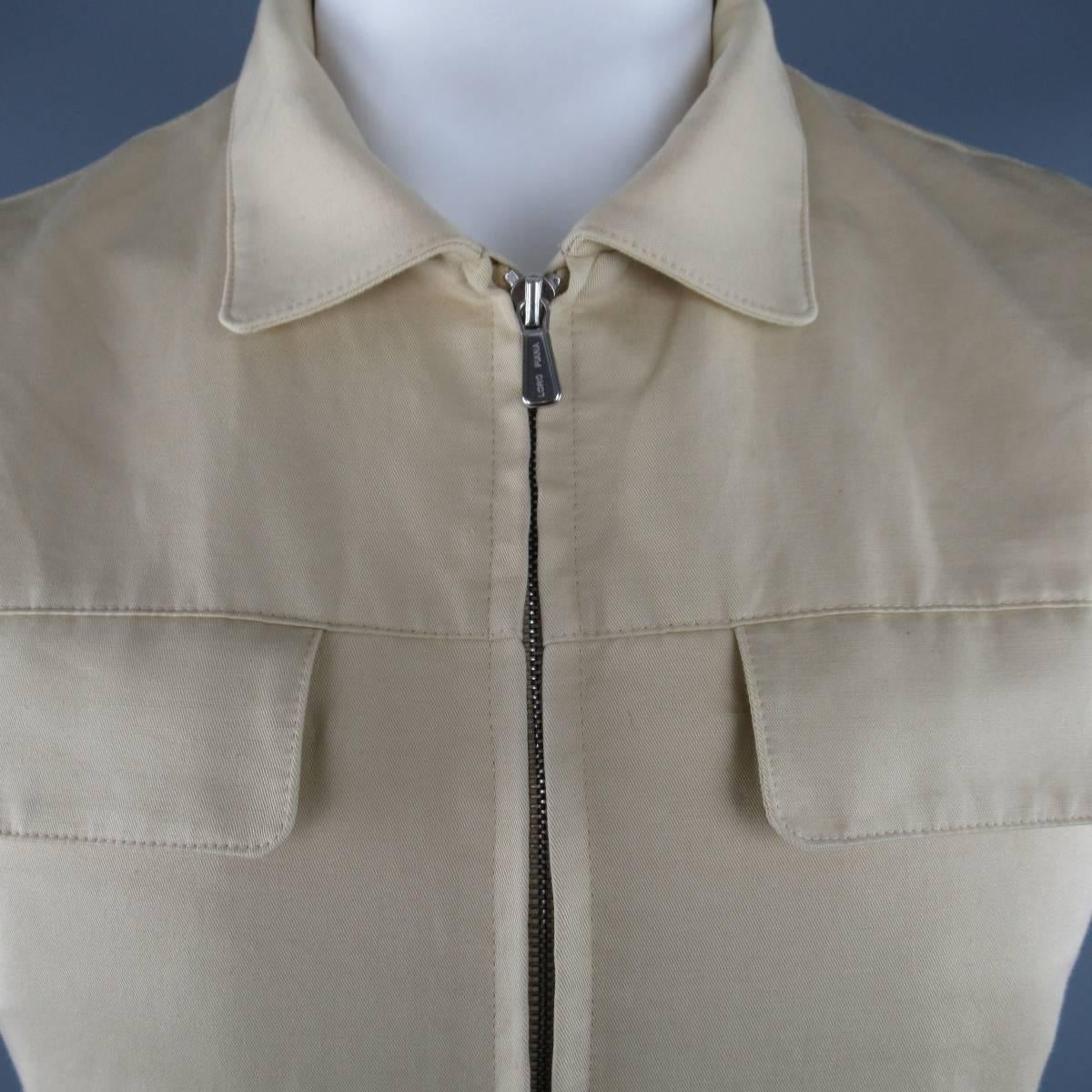 Classic LORO PIANA vest comes in rich khaki cotton linen blend fabric and features a double zip front, pointed collar, side slit pockets with tan suede accents, flap breast pockets,  and ribbed knit side panels. Made in Italy.
 
Good Pre-Owned