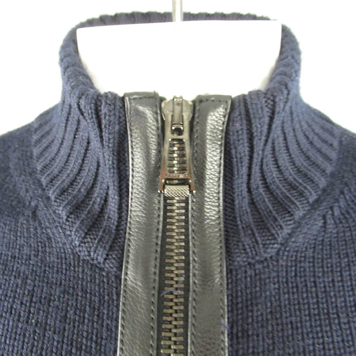 BELSTAFF Zip-Up Cardigan consists of wool knit material in a navy color tone. Designed with a high rib collar, zip-up front and knit pattern. Detailed with leather front trimming and elbow/ forearm patches. Comes with original tags. Made in Italy.
